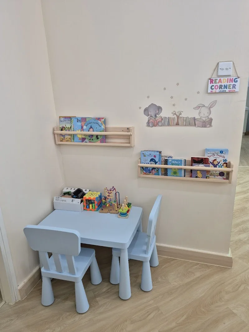 Children’s play corner with table, chairs and books