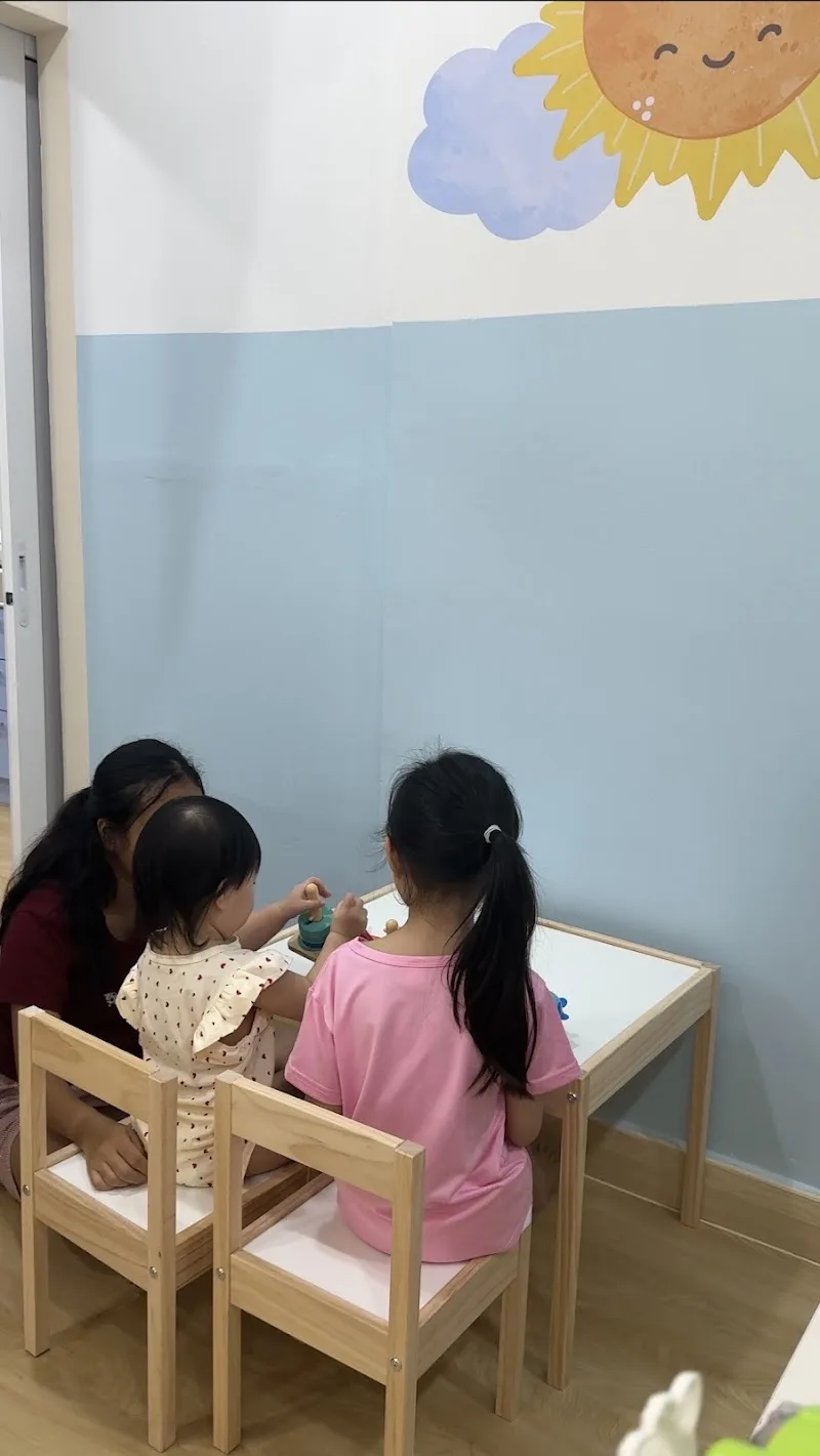Children drawing together at the play table in the clinic